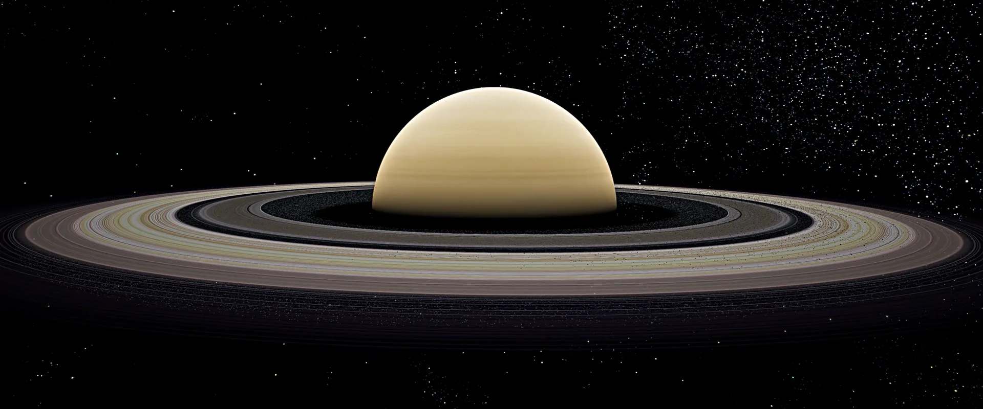 Saturn from orbit: the ringed planet centred on the far wall, stars around the room